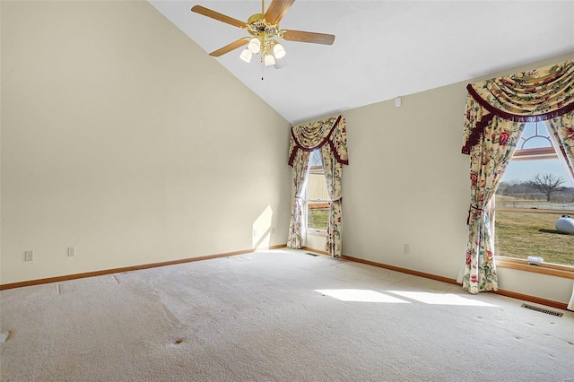 carpeted empty room featuring a ceiling fan, a healthy amount of sunlight, visible vents, and high vaulted ceiling