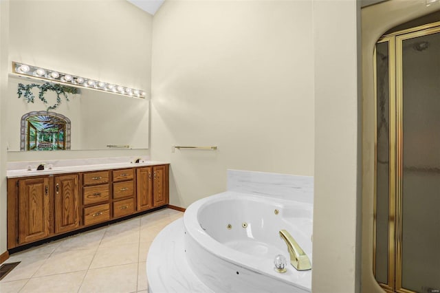 full bathroom with tile patterned floors, a jetted tub, a shower stall, and a sink