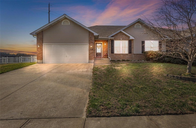 ranch-style house featuring brick siding, fence, concrete driveway, a garage, and a yard