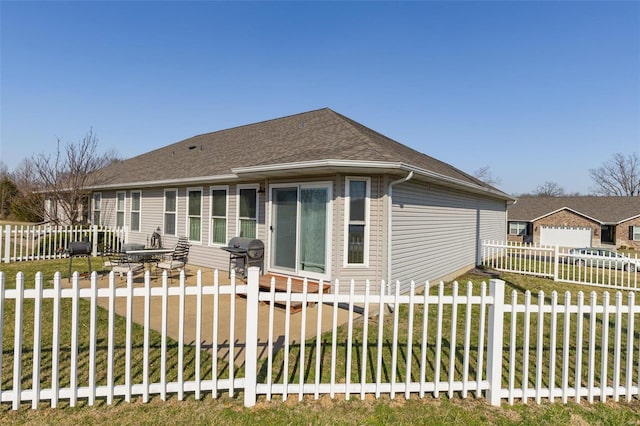 back of property featuring fence private yard and roof with shingles