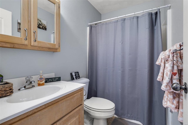 bathroom with vanity, curtained shower, and toilet