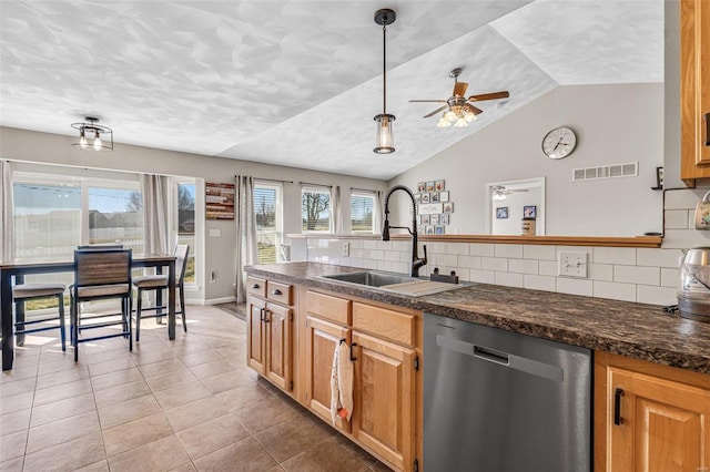 kitchen with visible vents, a sink, dark countertops, dishwasher, and ceiling fan