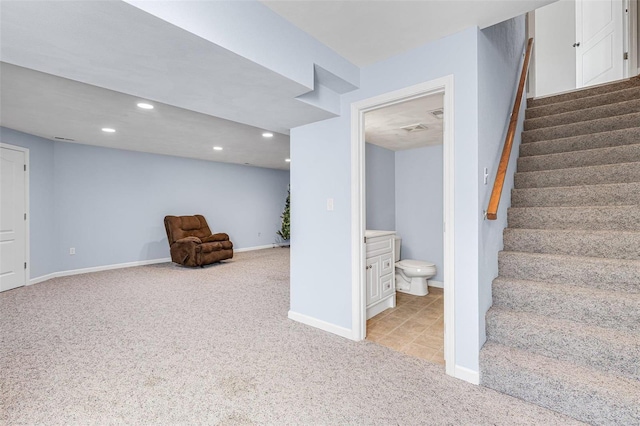 finished below grade area featuring recessed lighting, light colored carpet, stairs, and baseboards