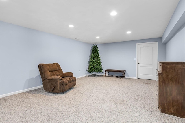 sitting room with recessed lighting, light colored carpet, and baseboards