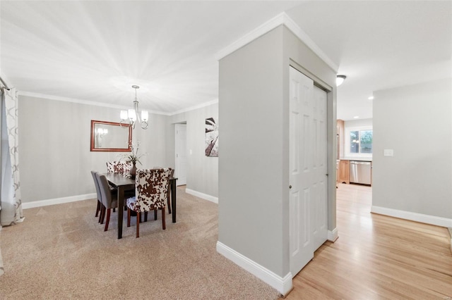 dining area featuring a chandelier, baseboards, and ornamental molding