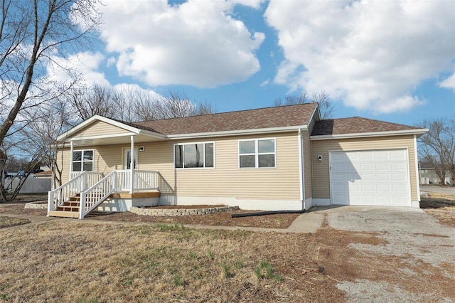 ranch-style home with an attached garage, a shingled roof, and driveway