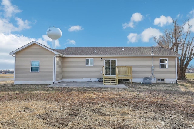 rear view of property with a patio, central AC, and roof with shingles