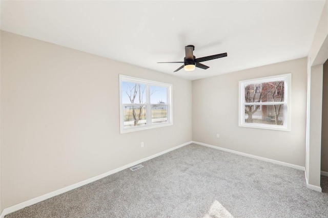 unfurnished bedroom with visible vents, baseboards, carpet, and a ceiling fan