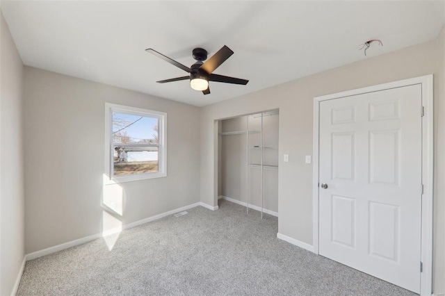 unfurnished bedroom with visible vents, ceiling fan, baseboards, carpet floors, and a closet