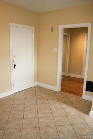 entrance foyer with baseboards and light tile patterned flooring