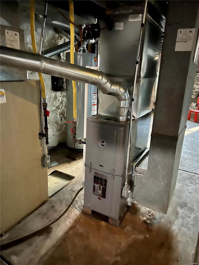 utility room featuring heating unit and gas water heater