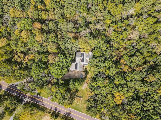 drone / aerial view with a wooded view