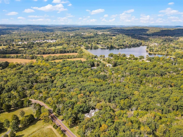 aerial view featuring a wooded view and a water view