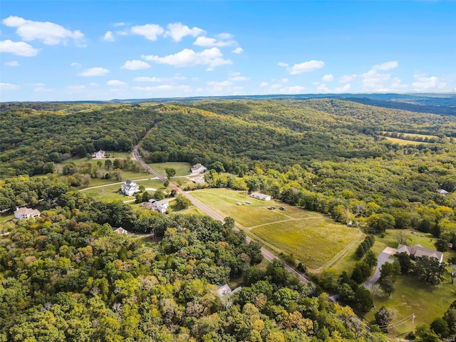 birds eye view of property featuring a view of trees