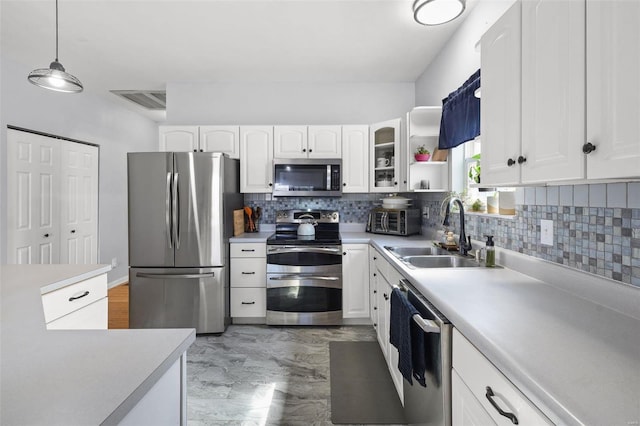 kitchen featuring a sink, white cabinets, visible vents, and stainless steel appliances