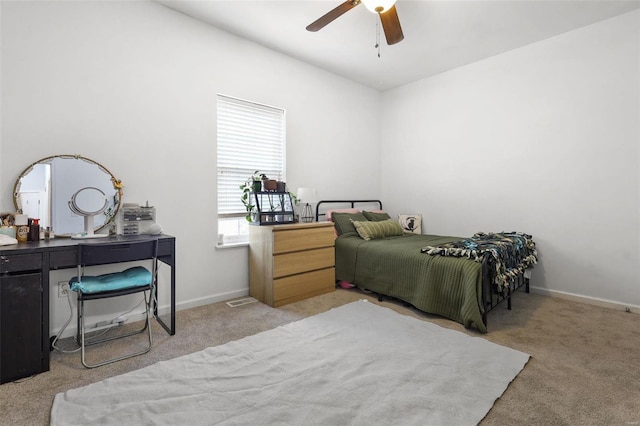 bedroom with baseboards, carpet floors, and a ceiling fan