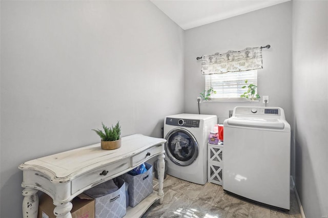 clothes washing area with washing machine and clothes dryer and laundry area