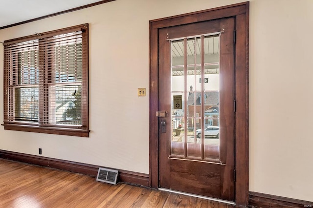 entrance foyer featuring baseboards, plenty of natural light, and wood finished floors