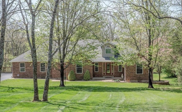 cape cod house featuring crawl space, brick siding, and a front yard