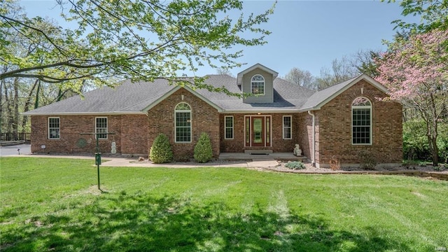 view of front facade with a front yard and brick siding