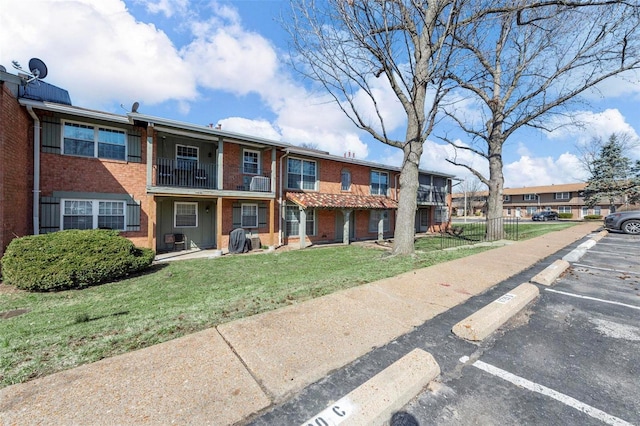 view of property featuring fence and uncovered parking