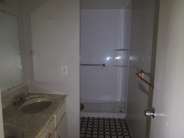 full bath with tile patterned floors, a shower stall, and vanity