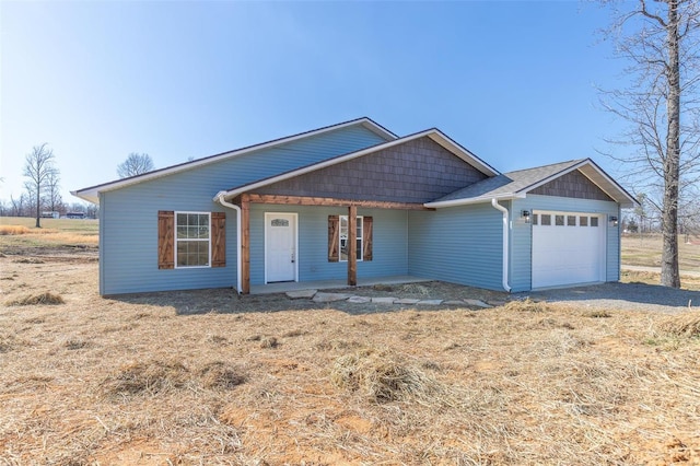 ranch-style house with a porch and an attached garage