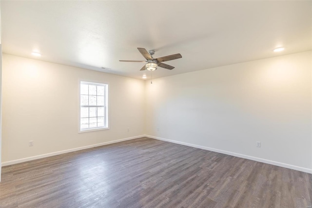 empty room featuring recessed lighting, baseboards, dark wood-style flooring, and ceiling fan