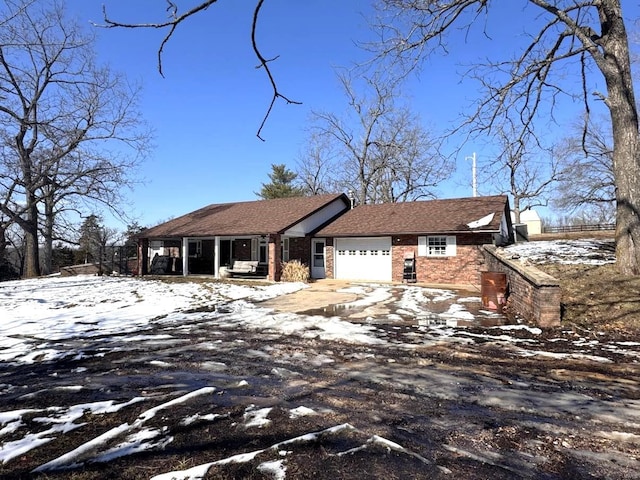 view of front of house featuring a garage and brick siding