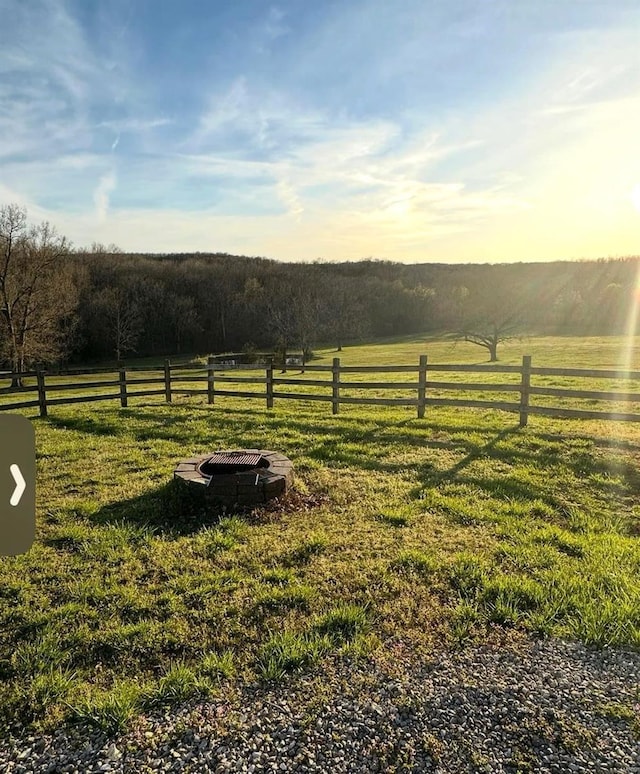 view of yard featuring a rural view and fence