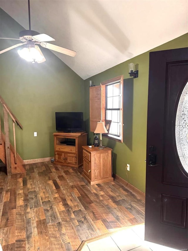 entrance foyer with ceiling fan, baseboards, dark wood-style floors, and vaulted ceiling