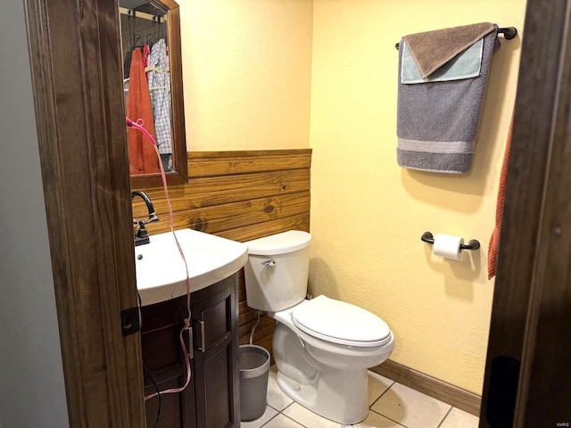 bathroom with tile patterned floors, baseboards, toilet, and vanity