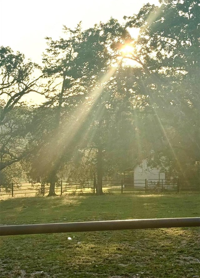 view of property's community featuring fence and a rural view