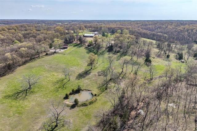 birds eye view of property featuring a view of trees