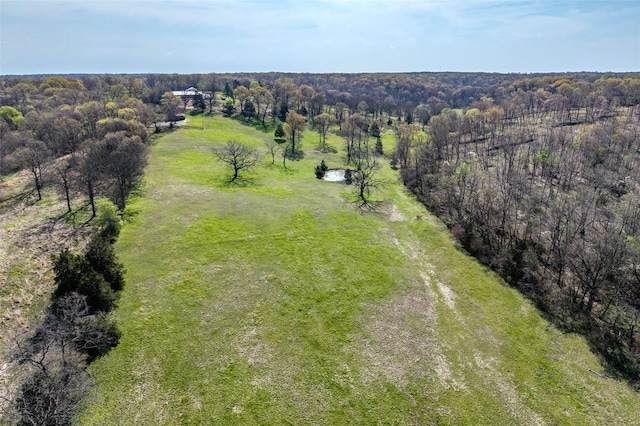 aerial view featuring a wooded view