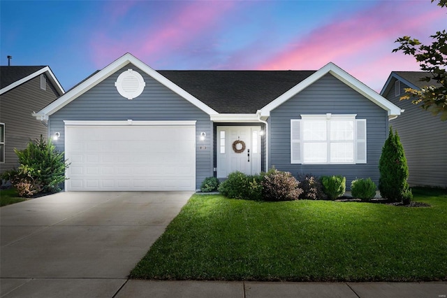 ranch-style home with an attached garage, a lawn, driveway, and a shingled roof