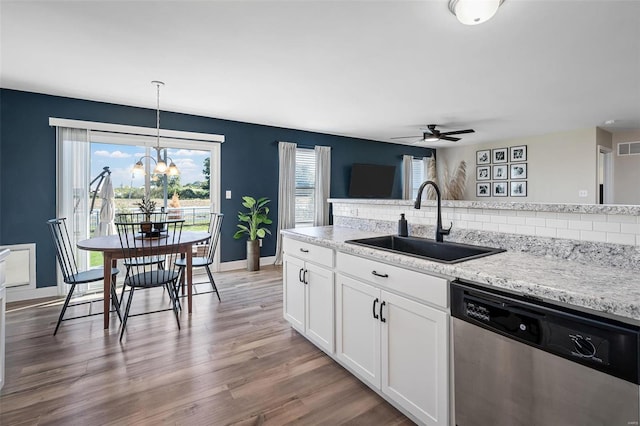 kitchen with tasteful backsplash, dishwasher, light wood-type flooring, a wealth of natural light, and a sink