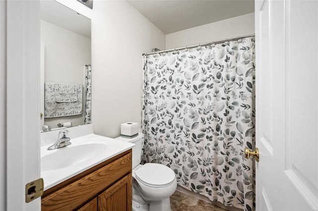 bathroom featuring toilet, vanity, and a shower with curtain