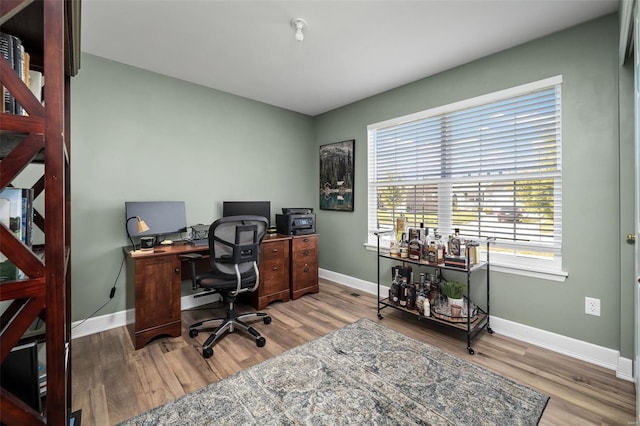 office space featuring wood finished floors and baseboards