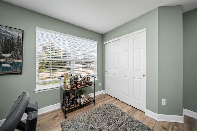 office space with wood finished floors and baseboards