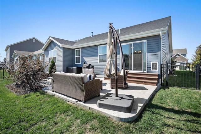 back of property with a lawn, entry steps, outdoor lounge area, and fence