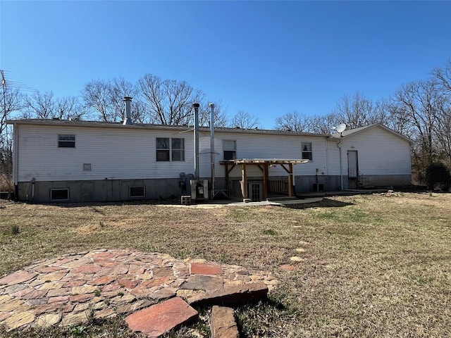 rear view of property featuring a yard, a patio, and a pergola