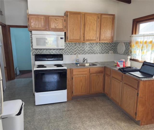 kitchen featuring a sink, backsplash, range with electric stovetop, and white microwave