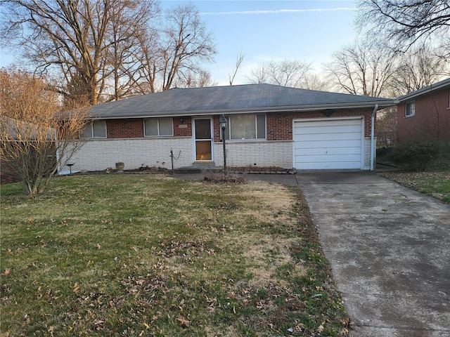 single story home with a front yard, concrete driveway, brick siding, and a garage