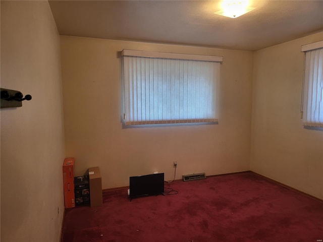 carpeted spare room with visible vents