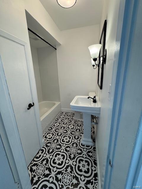 full bathroom with tile patterned floors and a bath