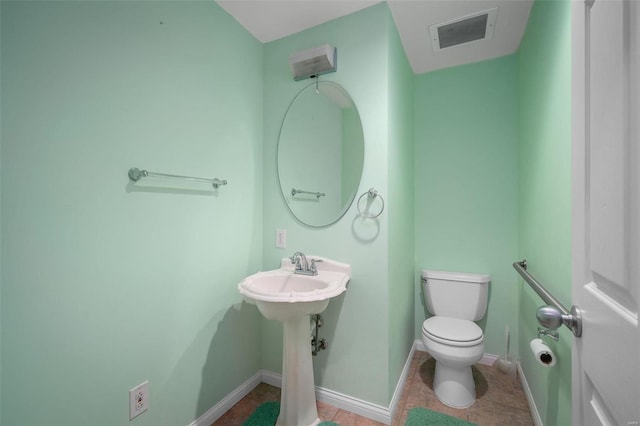 bathroom featuring visible vents, baseboards, toilet, and tile patterned flooring