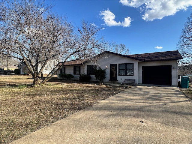 single story home with aphalt driveway and an attached garage