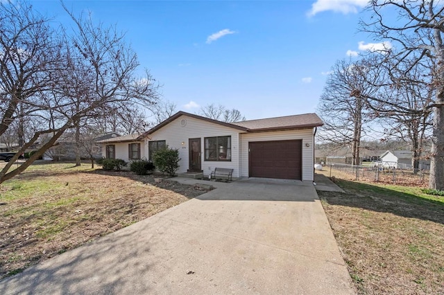 single story home with concrete driveway, an attached garage, and fence