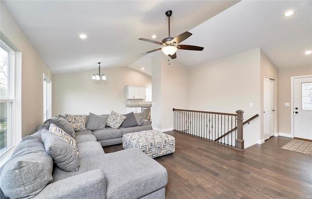 living room featuring wood finished floors, baseboards, lofted ceiling, recessed lighting, and ceiling fan with notable chandelier